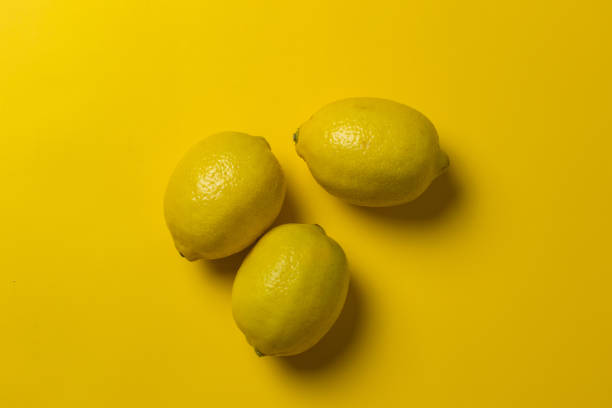 istock yellow lemons in a yellow background 1464701035