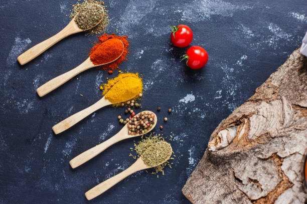 istock Wooden spoons with spices, paprika, basilic, pepper, thyme with cherry tomatoes 1464701678