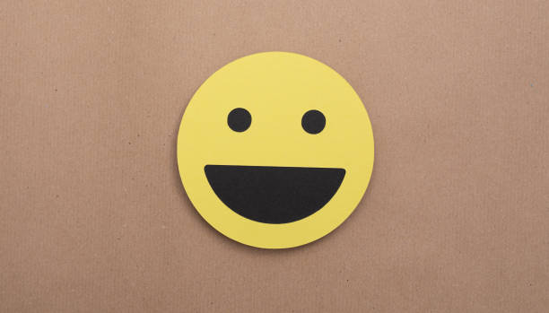 istock Yellow smiley emoji on a brown background, positive emotion concept 1464702429