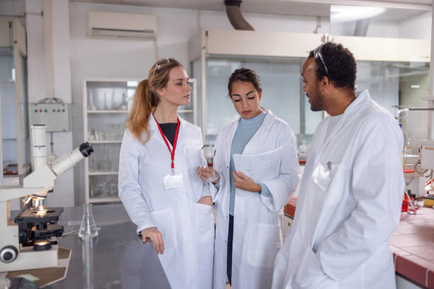 istock Multiracial Group Of Scientists Discussing Their Results At The Laboratory 1464703286