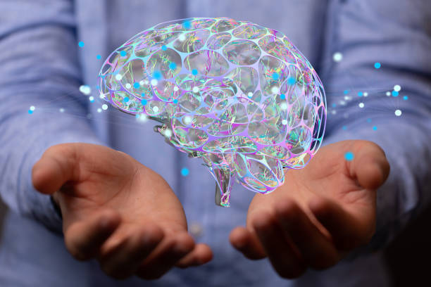 istock Person presenting the virtual projection of the human brain surrounded by network 1464703912