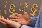 Closeup of a 3D rendered paragraph law signs in man's hand