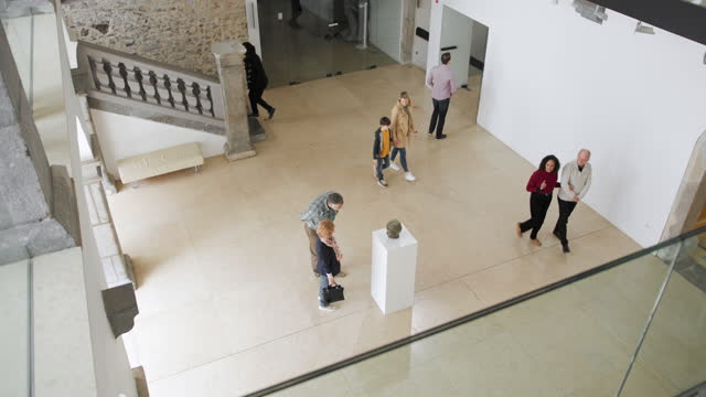 Overhead View Of A Museum Full Of Visitors On A Sunday Morning