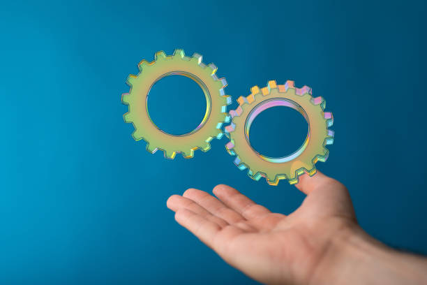 istock 3D gears above a hand on a blue background 1464705133