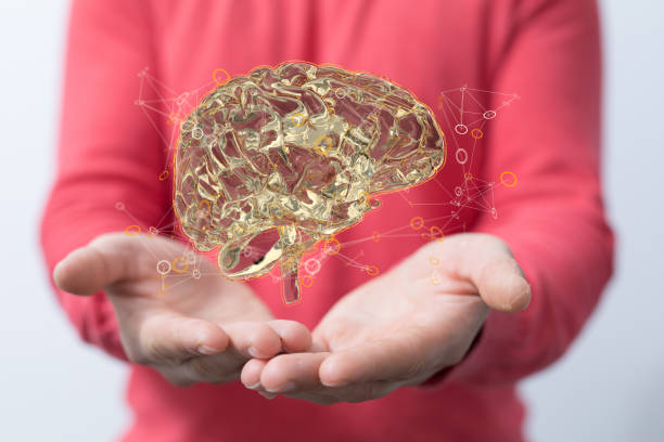 istock 3D rendering of a gold human brain floating above a man's hands with a blurry background 1464705191