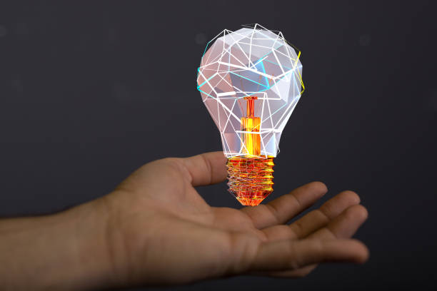 istock 3D rendered futuristic lightbulb hovering over a man's hand against a black background 1464705492