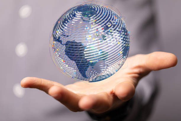 istock Closeup of a 3D rendered globe hologram hovering over a man's palm 1464705601