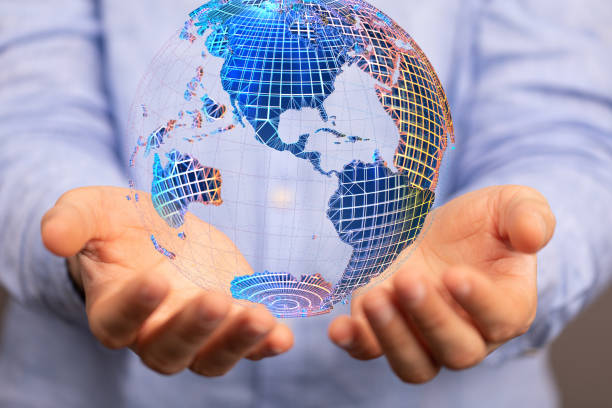 istock Closeup of a 3D rendered globe hologram hovering over man's hands 1464705615