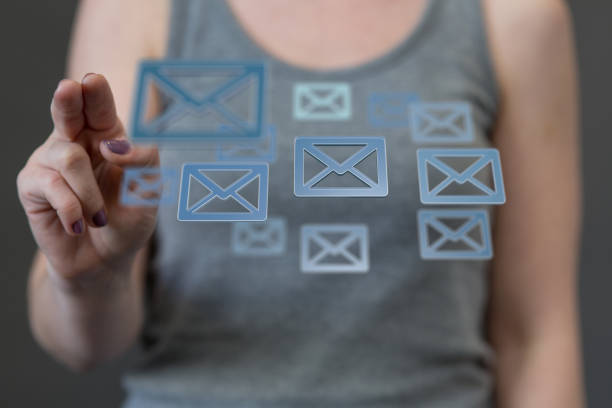 istock Digital concept of using the internet for communication, finger pointed at floating email icons 1464707157