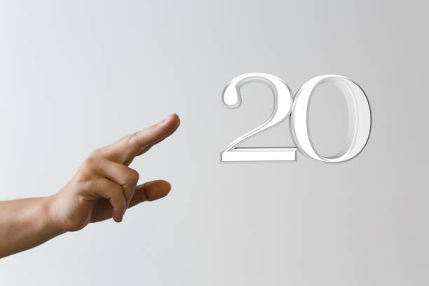 istock Person pointing at the number 20 isolated on a gray background 1464707313