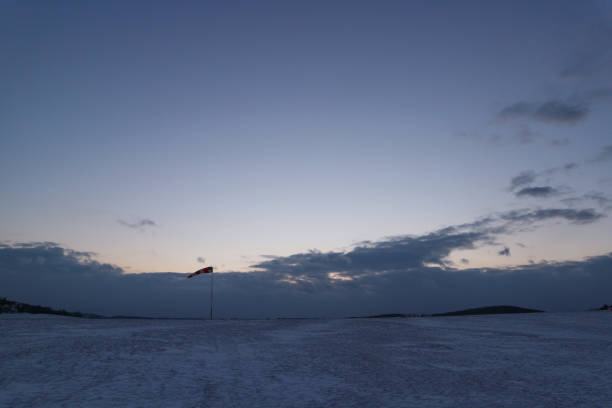 The wind indicator in the snowy airport during sunset at Brno, Czech republic