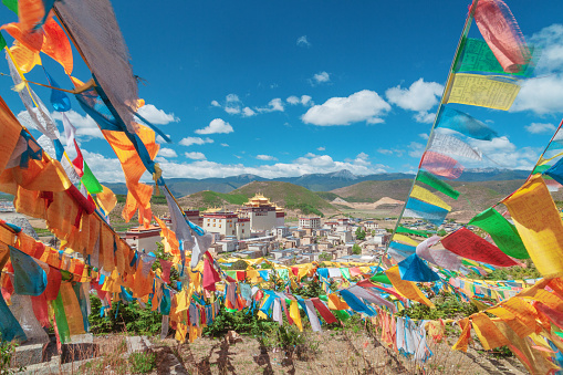 Colored flags on the background of a Buddhist monastery. China