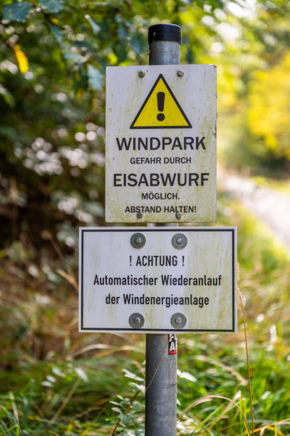 istock Close-up german yellow warning sign attention ice can fall down from the wind turbine 1464708251