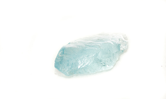 light blue beryl jewel cut crystal on a white background