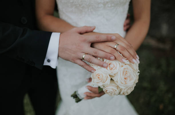 istock Newlyweds holding hands on the bridal bouquet 1464708801