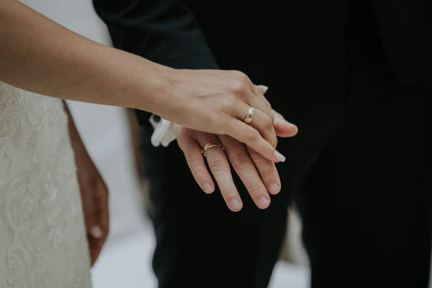 istock Newlywed couple holding hands 1464708806