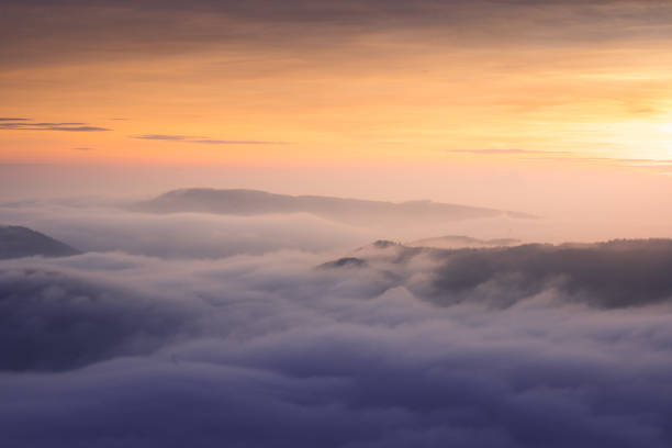 istock Closeup shot of clouds under an orange sunset sky 1464708930