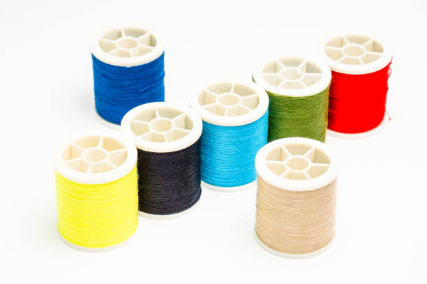 istock Closeup of various colorful sewing threads on the white surface 1464708937