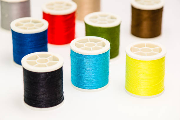 istock Closeup of various colorful sewing threads on the white surface 1464708939