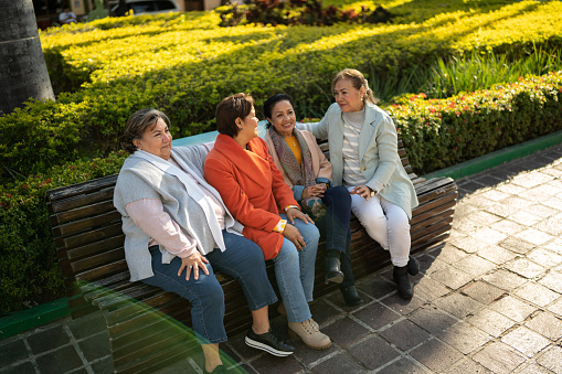 Senior friends talking outdoors