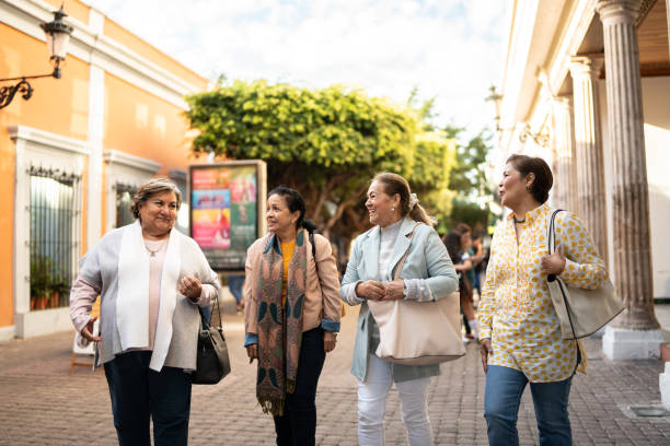istock Senior friends talking and walking outdoors 1464710232