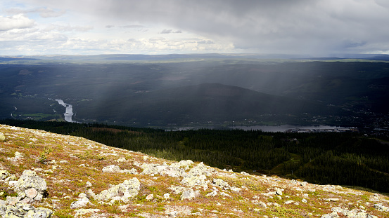 A beautiful view of the Light, shadow, and rain on a mountain top in  Trysil, Norway