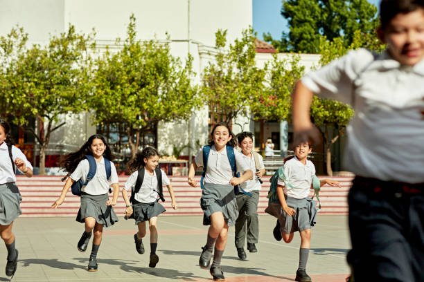 istock Grinning young students racing each other across sunny quad 1464711092