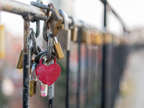 istock Heart-shaped padlock locked on the fence 1464711697