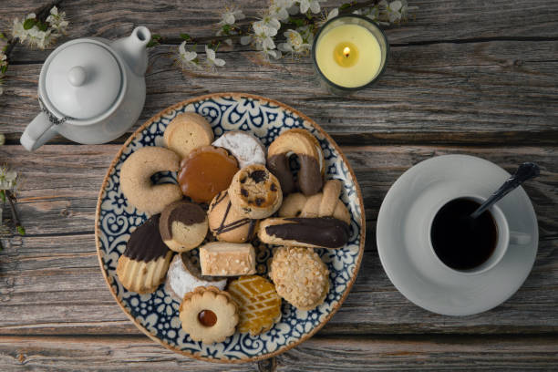 istock Top view of a coffee table with biscuits on a plate and a cup of coffee 1464712357