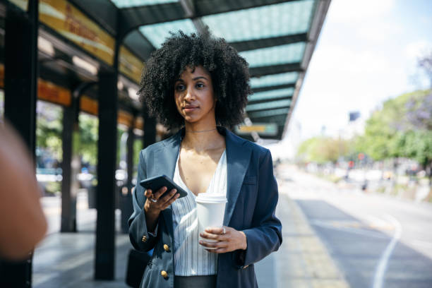 istock Businesswoman waiting at bus stop 1464713221