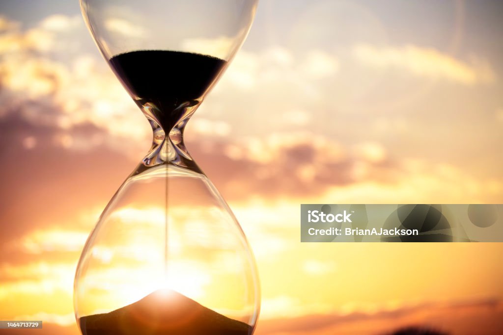 Hourglass at sunset background with copy space Hourglass at sunset and sky background with copy space Hourglass Stock Photo