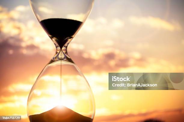 Hourglass At Sunset Background With Copy Space Stock Photo - Download Image Now - Hourglass, Time, Sun