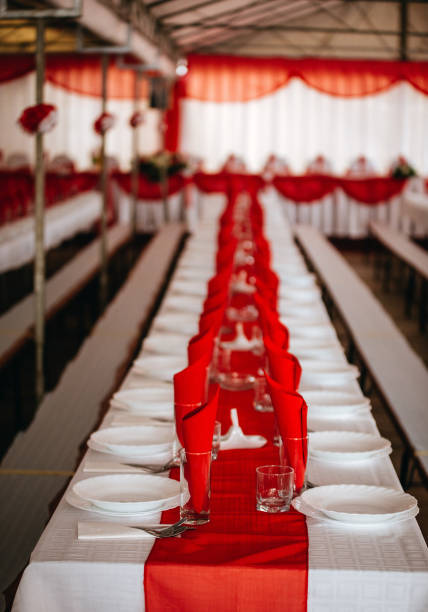 istock Red-themed wedding table decoration with red napkins and empty glasses 1464713895