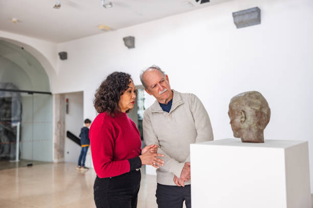 istock Senior Diverse Couple Having A Conversation While Looking At A Statue In A Museum 1464714758