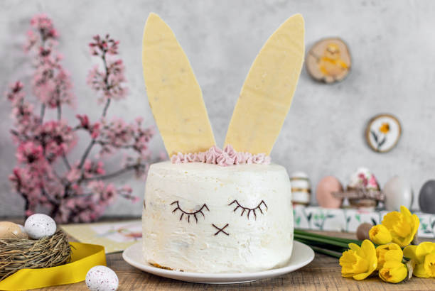 Easter cake decorated as a bunny. Holiday, food, desert, spring, easter eggs, flowers. Home baked easter cake decorated as a cute bunny. Bunny ears made of white chocolate, easter eggs, holiday, easter, food, baking, dessert, flowers. easter cake stock pictures, royalty-free photos & images