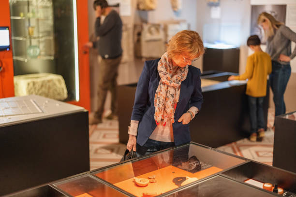istock Senior Caucasian Female Educating Herself On History While Visiting The Museum 1464715042