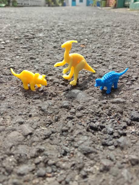 istock Collection of three colorful mini dinosaurs 1464716211