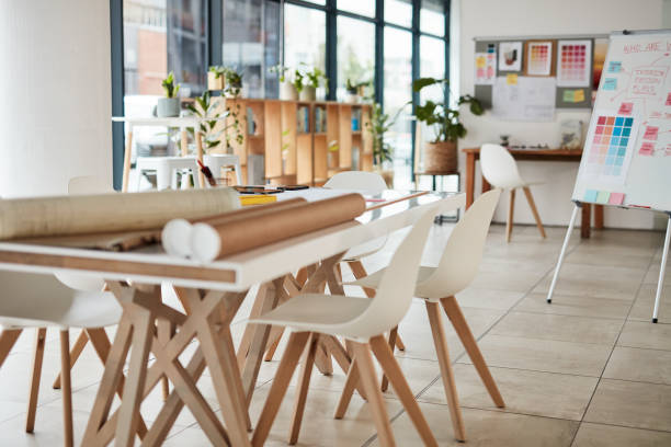 Creative, boardroom and advertising agency office with furniture for team meeting or planning. Company, creativity and modern minimal interior design with a artistic coworking space in the workplace. stock photo