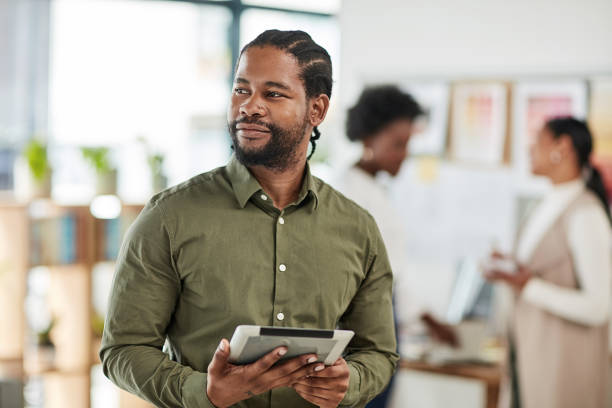 istock Creative black man, tablet and design in focus for planning, strategy or inspiration for startup. African American male employee designer working on touchscreen for web or online research 1464716412