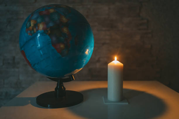 istock Globe and a burning candle in the room. 1464716952