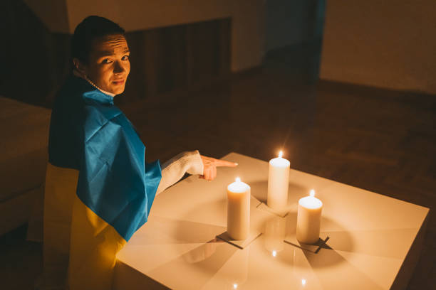 istock Scared woman showing on a candle during war 1464717749