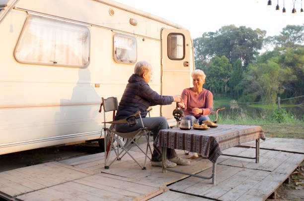 istock Two senior woman talking and leisure in camping, elderly doing activity recreation and leisure picnic while breakfast together in morning in weekend, travel trip in holiday, party in vacations. 1464718098