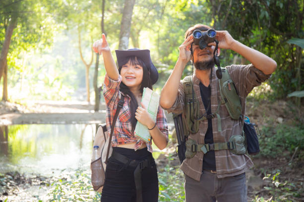 istock Family with father and daughter tourist backpack hiking doing activity while father looking binoculars in holiday together, man and teenager woman journey adventure trip and looking map. 1464718598