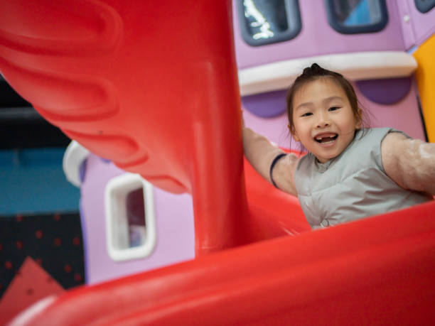 istock little girl playing on slide 1464719057