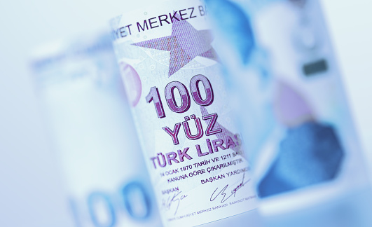 Rolled up 100 Turkish Lira bills. Horizontal composition with copy space. Finance concept.