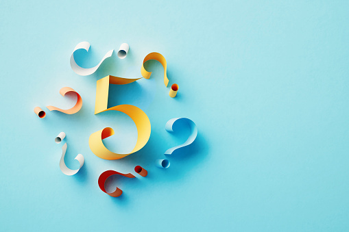 Yellow number 5 surrounded by colorful question marks over blue background. Horizontal composition with copy space.