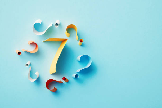 istock Yellow Number 7 Surrounded By Colorful Question Marks On Blue Background 1464723018