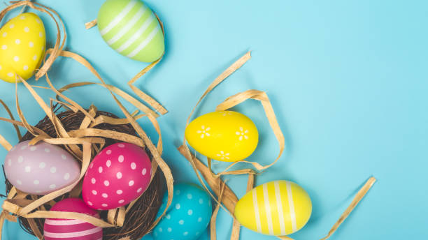 istock Happy Easter concept. Preparation for holiday. Easter eggs on the nest isolated on blue background. Simple minimalist flat lay top view copy space 1464726589