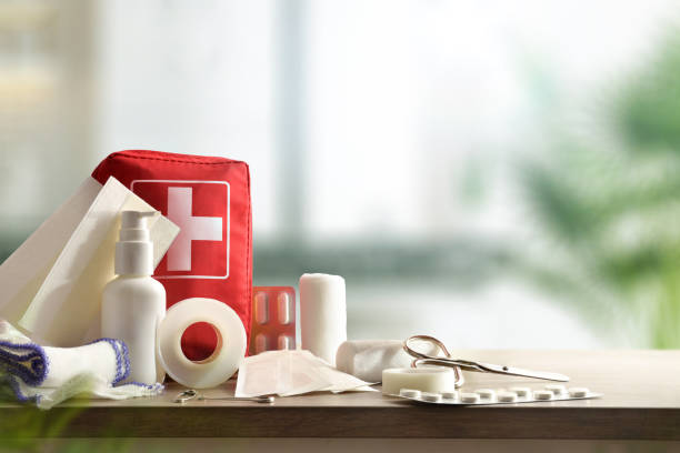 Emergency home kit on wooden table and warm room background stock photo