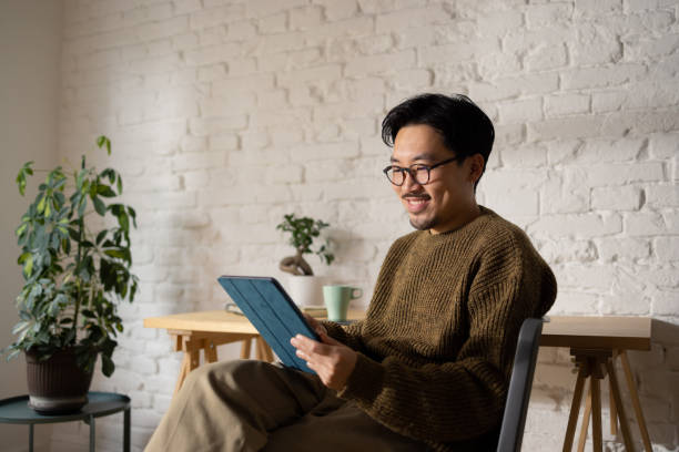 istock A serious-looking Chinese man in his 30s using a tablet at home 1464727660